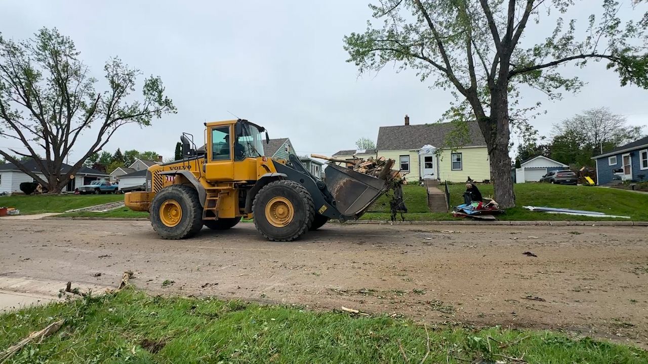 Heavy equipment is being used to clean debris in Mayville afterpart of the city was hit with an EF-2 tornado May 15.