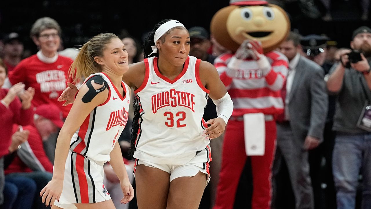 Ohio State's Cotie McMahon, right, and Jacy Sheldon, left, celebrate near the end of overtime as Ohio State defeats Iowa in an NCAA college basketball game Sunday, Jan. 21, 2024, in Columbus, Ohio. (AP Photo/Sue Ogrocki)