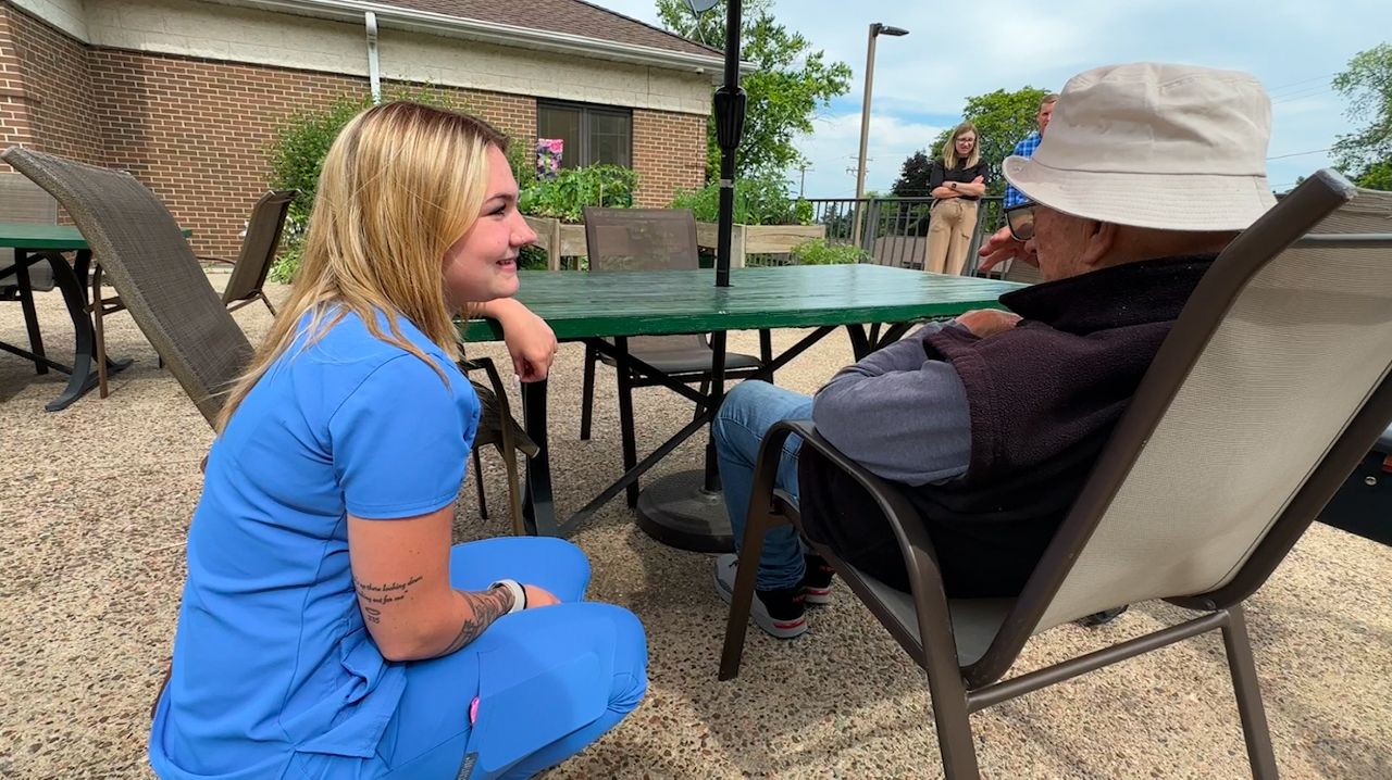 Tiahna Tilot spends time with a resident at McCormack Assisted Living in Allouez, Wisconsin.