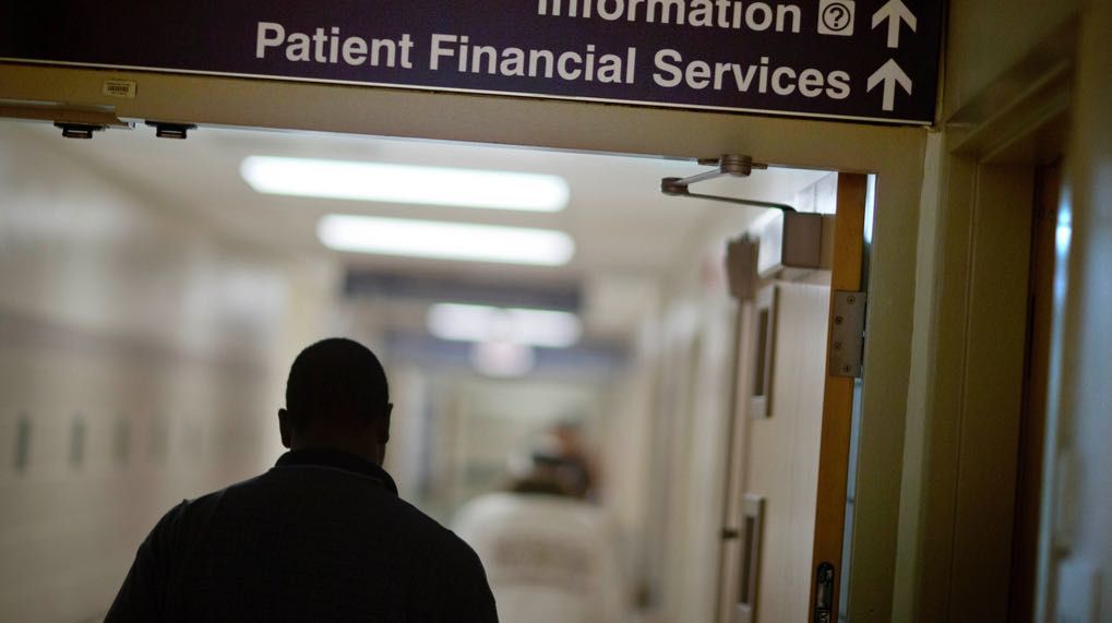A sign points visitors toward the financial services department at a hospital, Friday, Jan. 24, 2014. (AP Photo/David Goldman, File)