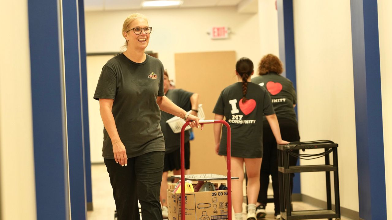 Volunteers from Texas Roadhouse move Meredith-Dunn School into its new building