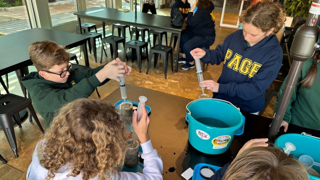 Students from Page Academy build mini ground wells at the Mesa Water District in Costa Mesa.