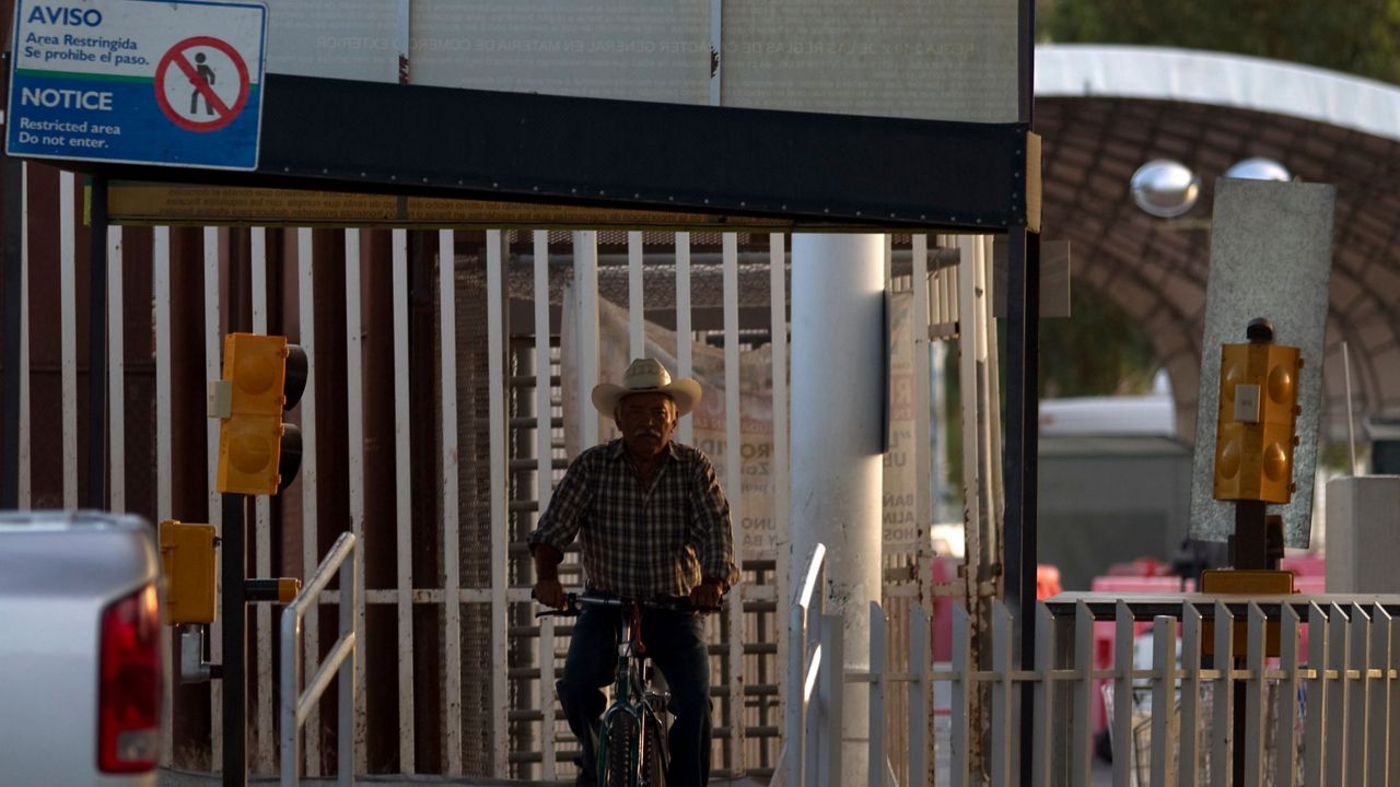 A man rides his bike through the Mexican port of entry in San Luis Rio Colorado, Mexico, July 29, 2010. (AP Photo/Guillermo Arias, File)