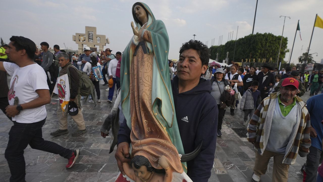 Pilgrims gather outside of the Basilica of Our Lady of Guadalupe a day before her feast day in Mexico City, Wednesday, Dec. 11, 2024. (AP Photo/Fernando Llano)