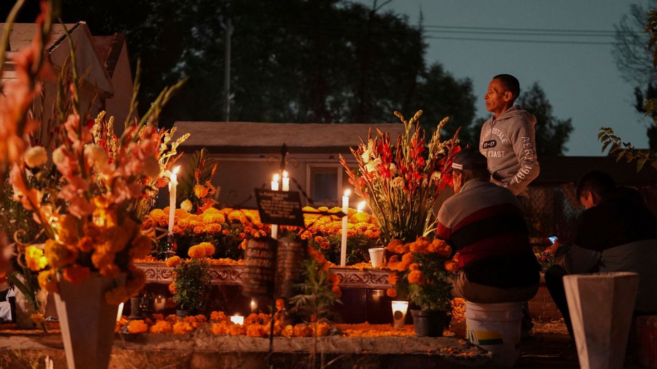 Families gather by the tomb of their dearly departed, as they celebrate the Day of the Dead, at the San Gregorio Atlapulco cemetery on the outskirts of Mexico City, Friday, Nov. 1, 2024. (AP Photo/Moises Castillo)