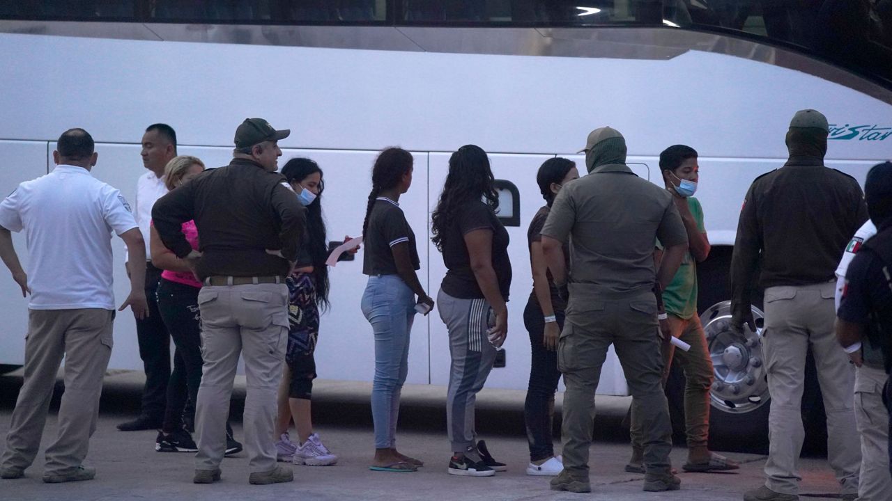 Migrants stand in line to board a bus after being deported from the U.S. side back to Matamoros, Mexico, May 11, 2023. (AP Photo/Fernando Llano, File)