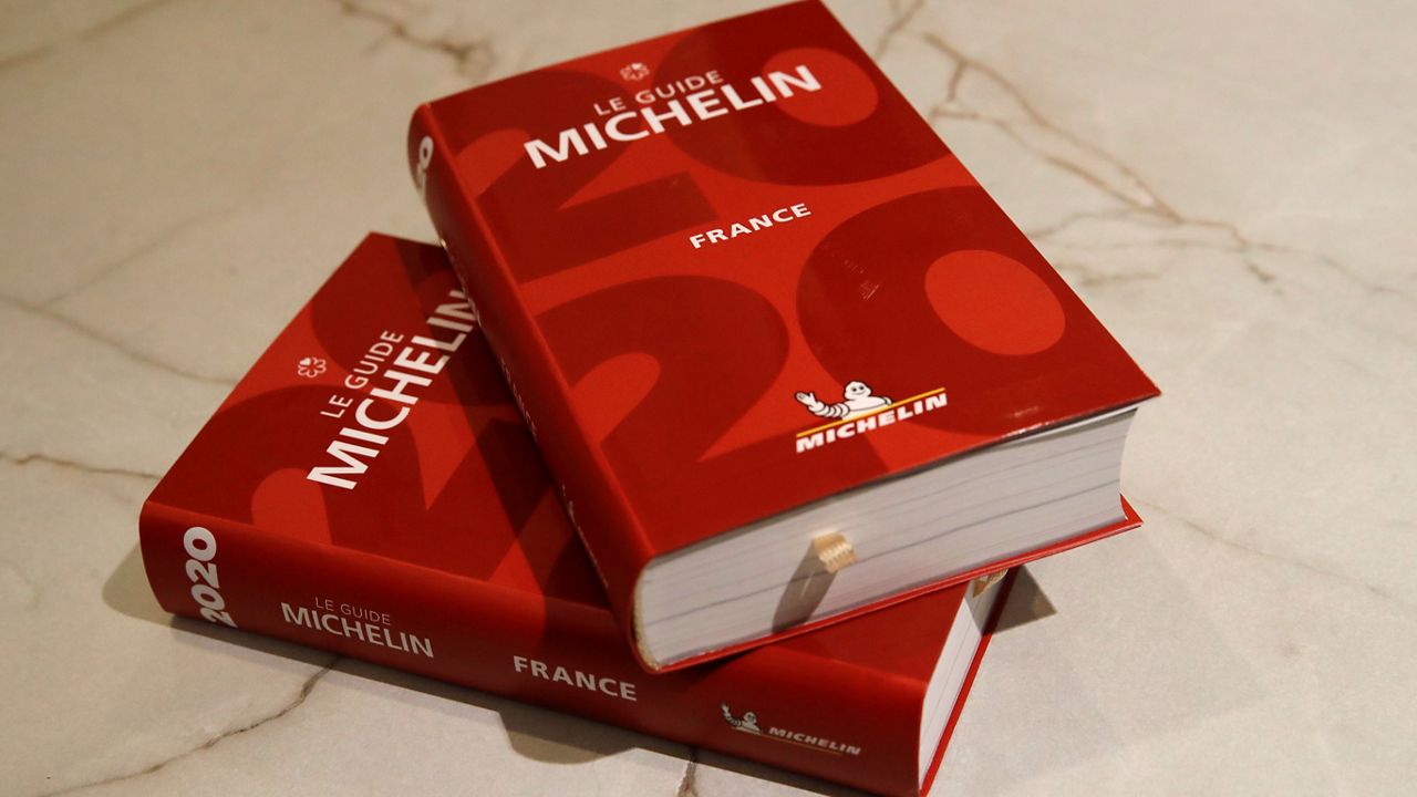 The Michelin guide is pictured during the Michelin guide ceremony Monday, Jan. 27, 2020 in Paris. (AP Photo/Christophe Ena)