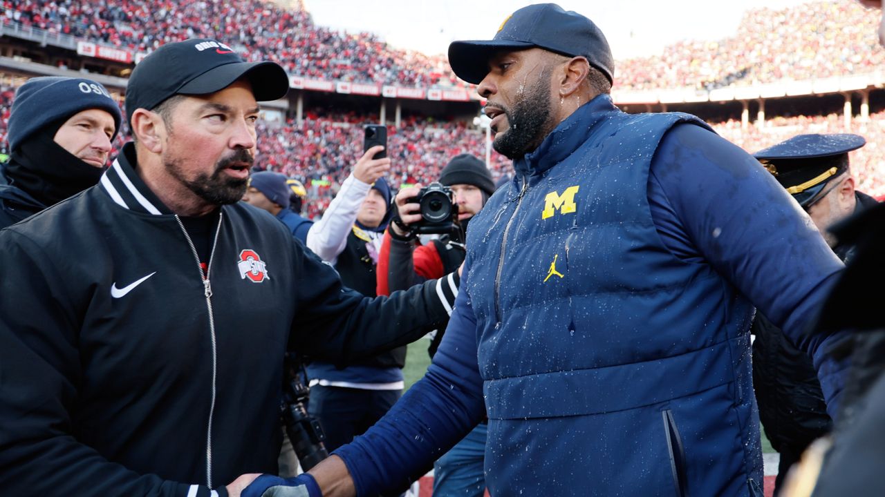 Ohio State head coach Ryan Day, left, and Michigan head coach Sherrone Moore shake hands after an NCAA college football game Saturday, Nov. 30, 2024, in Columbus, Ohio.