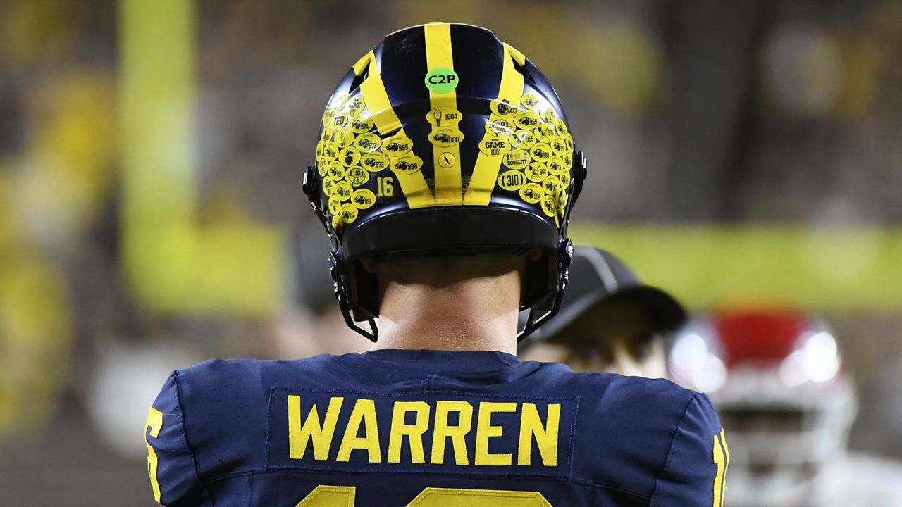 Michigan quarterback Davis Warren prepares to hike the ball against Fresno State in the second half of an NCAA college football game, Saturday, Aug. 31, 2024, in Ann Arbor, Mich. (AP Photo/Jose Juarez)