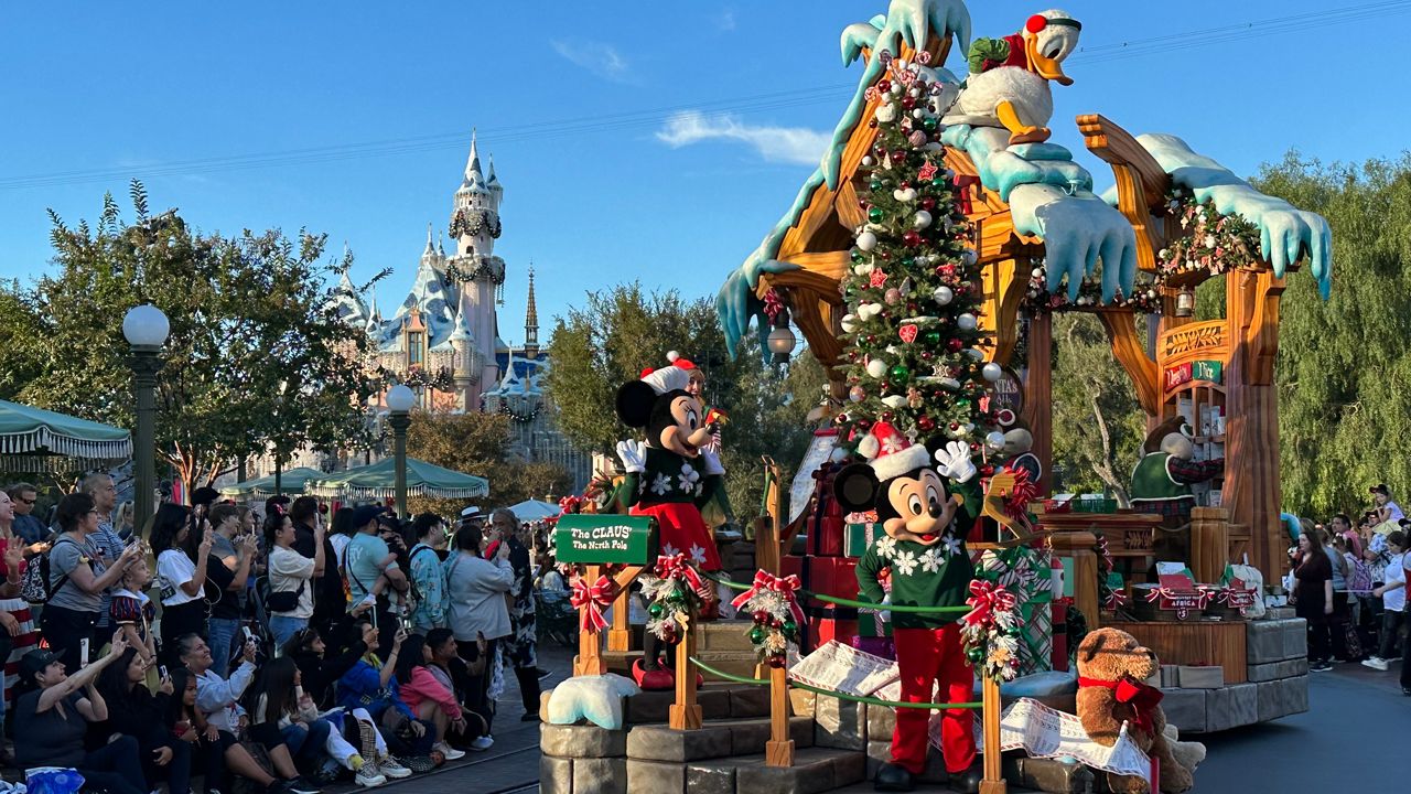 Mickey and Minnie Mouse and Donald Duck mascot actors parade down Main Street, U.S.A. during the Christmas Fantasy parade at Disneyland. (Spectrum News/Joseph Pimentel)