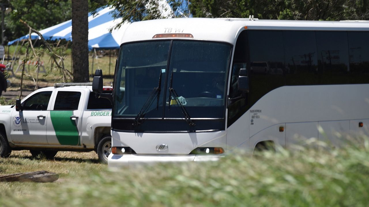 A Border Patrol vehicle and bus are parked near a staging area near the U.S.-Mexico border in Brownsville, Texas, Saturday, April 29, 2023. (AP Photo/Valerie Gonzalez)