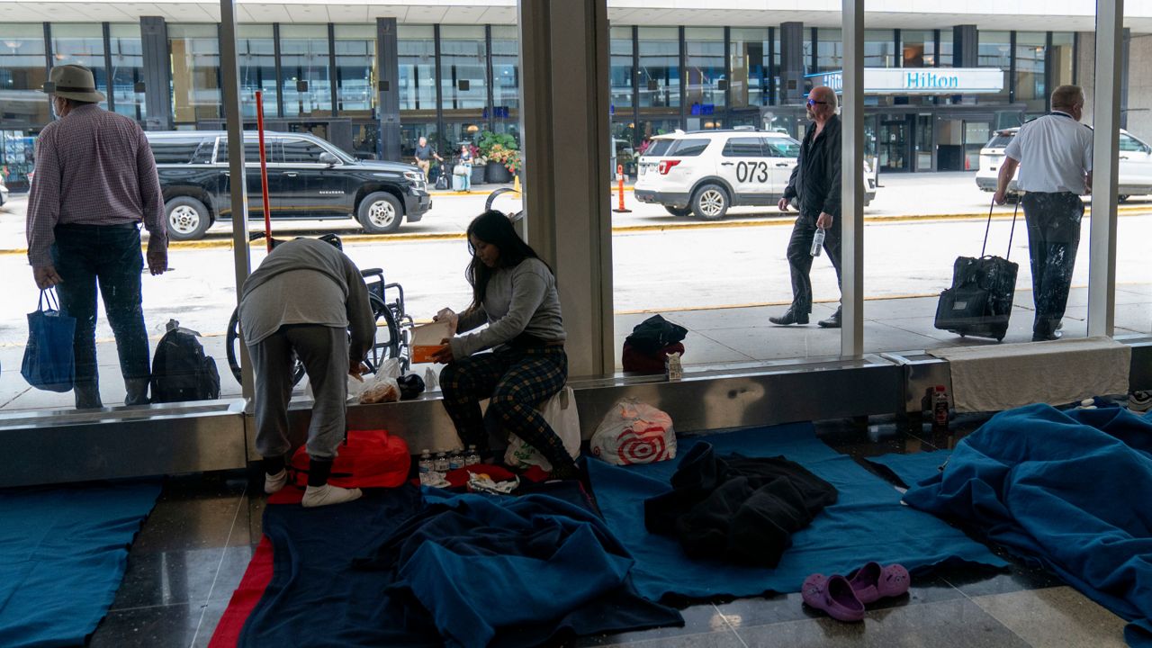 Run by a private firm hired by the city, migrants stay in a makeshift shelter at O'Hare International Airport, Wednesday, Sept. 20, 2023, in Chicago. Unlike migrants in the public eye at police stations, the migrants at O'Hare and a handful at Midway International Airport have limited access to resources, including showers and medical care. (AP Photo/Erin Hooley)