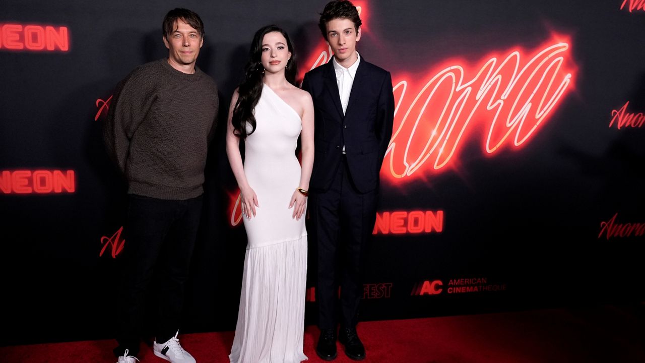 Sean Baker, left, writer/director of "Anora," poses with cast members Mikey Madison, center, and Mark Eydelshteyn 4at the premiere of the film, Oct. 1, 2024, at the Vista Theatre in Los Angeles. (AP Photo/ Chris Pizzello)