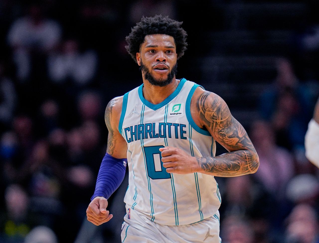 Charlotte Hornets forward Miles Bridges moves upcourt during the team's NBA basketball game against the Denver Nuggets, March 28, 2022, in Charlotte, N.C. The Charlotte Mecklenburg County Sheriff’s Office says it has an unserved warrant for Bridges for a violation of a domestic violence protective order along with an unserved criminal summons for a domestic protective order violation, misdemeanor child abuse and injury to personal property. The sheriff’s office said the warrant was issued in January and the criminal summons was issued Wednesday, Oct. 11. (AP Photo/Rusty Jones, File)