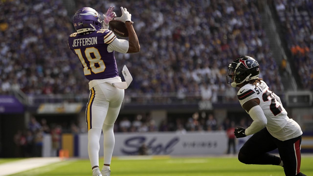 Minnesota Vikings wide receiver Justin Jefferson (18) catches a pass over Houston Texans cornerback Derek Stingley Jr. (24) during the first half of an NFL football game, Sunday, Sept. 22, 2024, in Minneapolis. (AP Photo/Abbie Parr)