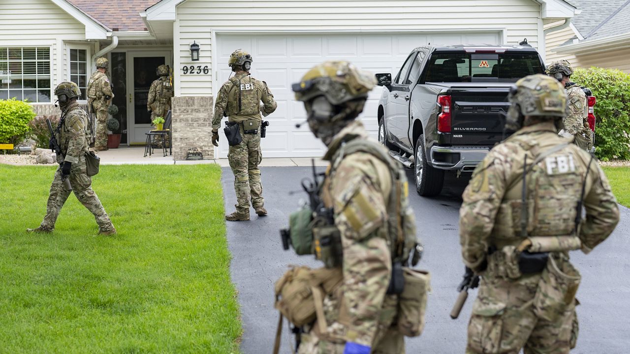 Armed FBI agents search for an active shooter, sweeping a neighborhood adjacent to the home of Minnesota DFL State Representative Melissa Hortman, in Brooklyn Park, Minn., Saturday, June 14, 2025. (Alex Kormann/Star Tribune via AP)