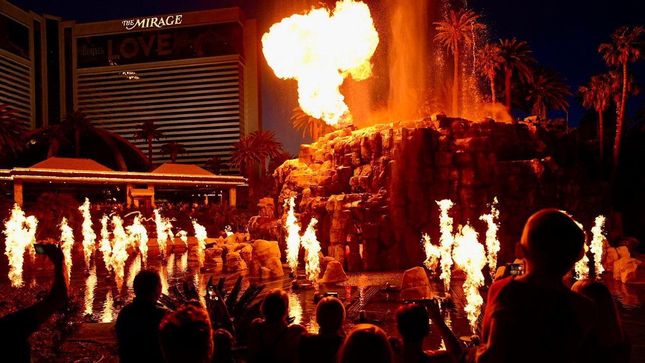 FILE - People watch the Volcano show at the Mirage hotel-casino along the Las Vegas Strip, May 13, 2022, in Las Vegas. The iconic Mirage hotel-casino on the Las Vegas Strip will shut its doors this summer on July 17, 2024, the end of an era for a property credited with helping transform Sin City into an ultra-luxury resort destination. (AP Photo/John Locher, File)