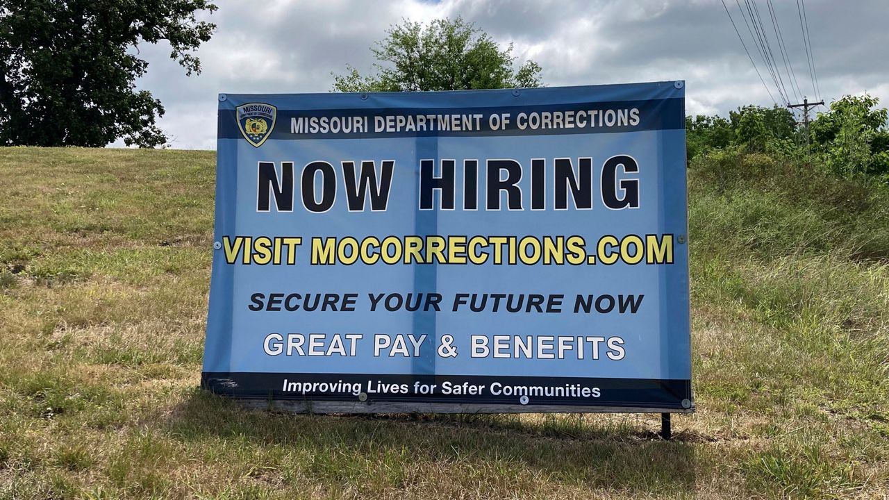 A "Now Hiring" sign is shown at the entrance to a Missouri Department of Corrections prison facility, Thursday, July 13, 2023, in Fulton, Mo. Nearly 1-in-4 positions were vacant late last year at the Department of Corrections. But vacancies have been declining since a pay raise was implemented this spring. (AP Photo/David A. Lieb)