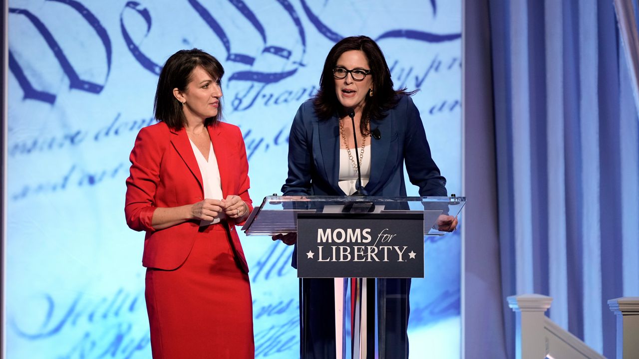 Moms for Liberty founders Tiffany Justice, right, and Tina Descovich speak at the Moms for Liberty meeting in Philadelphia, Friday, June 30, 2023. (AP Photo/Matt Rourke)