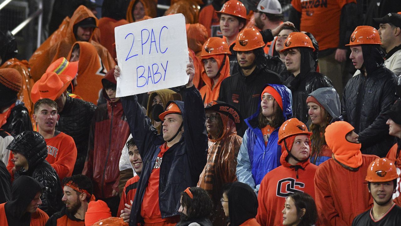 An Oregon State fan held up a sign about the Pac-12 Conference during the second half of the Beavers' game against Washington on Nov. 18 in Corvallis, Ore. OSU and Washington State will be the only remaining members of the Pac-12 next season and they have entered into a football alliance with the Mountain West Conference for a six-game crossover schedule starting in 2024.