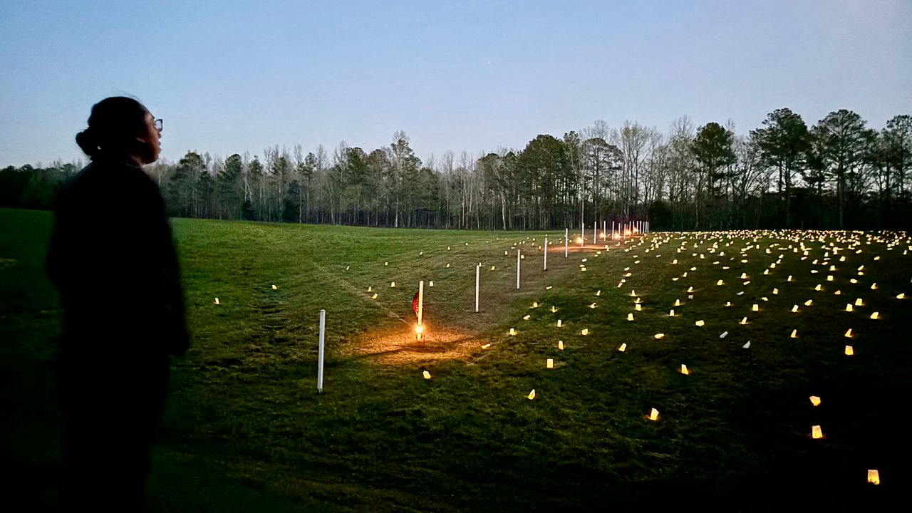 Jay Fife, language liaison for the Muscogee Nation, looks at luminaries set up at the site of the battle of Horseshoe Bend in Tallapoosa County, Ala., on Saturday, March 23, 2024. (AP Photo/Kim Chandler)