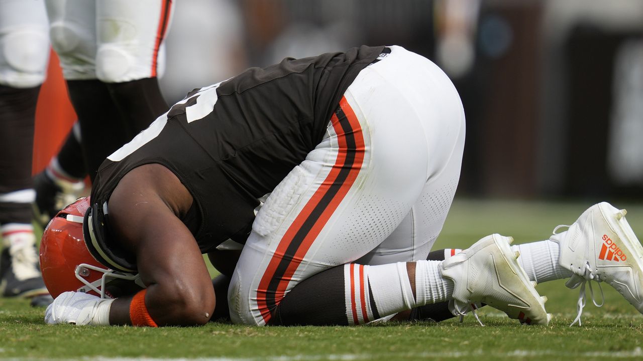 Cleveland Browns' Myles Garrett kneels on the field after an injury in the second half of an NFL football game against the New York Giants, Sunday, Sept. 22, 2024, in Cleveland. (AP Photo/Sue Ogrocki)