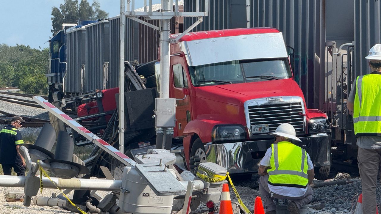 Melbourne police officers are investigating a crash involving a freight train and semi-truck Thursday morning at Lake Washington Road and North Harbor City Boulevard. (Spectrum News/Greg Pallone)