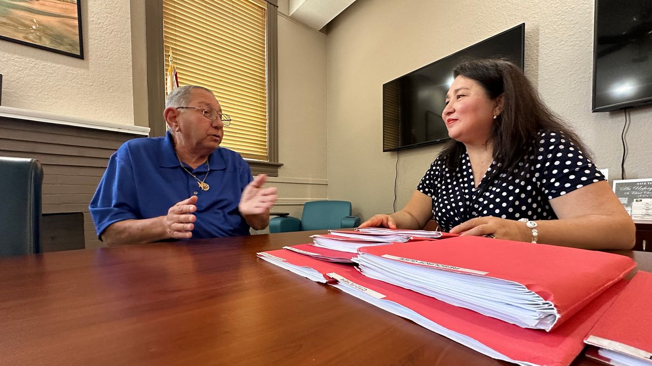 Founder of Connecting the Dots for Veterans, Helen Dottie Adams, meets with veteran Steven Olmeda at the St. Cloud Chamber of Commerce where Adams hosts an open house the first Saturday of every month to meet with veterans to see what resources they need to navigate the Veterans Affairs system. (Spectrum News/Devin Martin) 