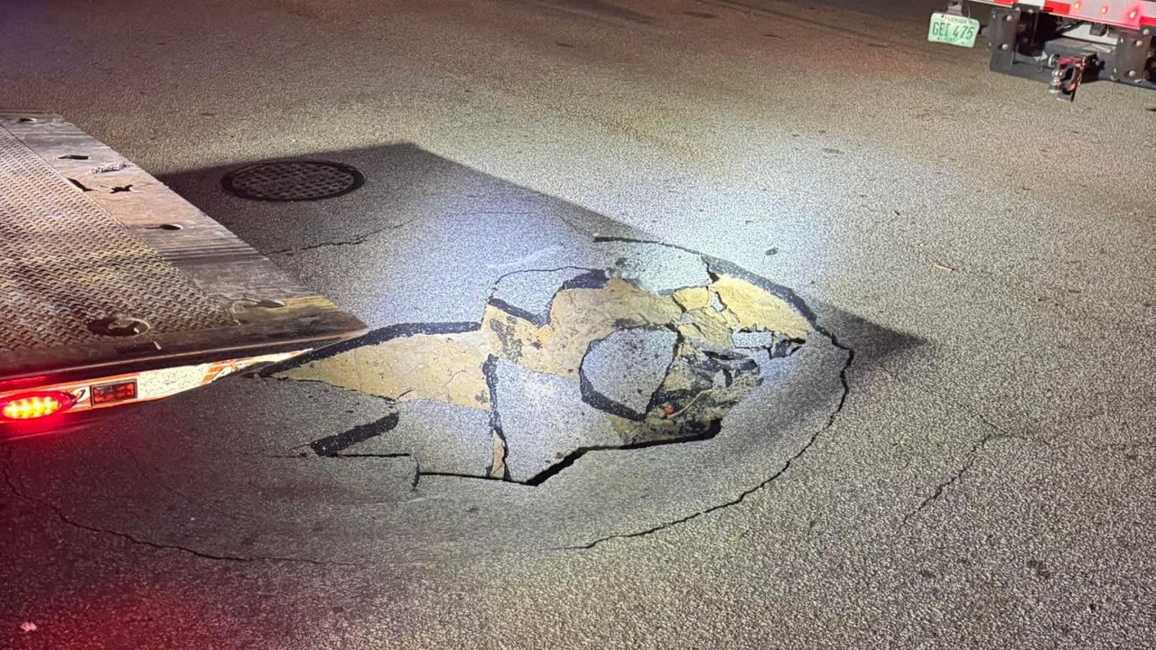 The Port Orange Police Department is warning residents of a pothole that opened Wednesday on Victoria Gardens Boulevard near Dunlawton Avenue. (Port Orange Police Department)