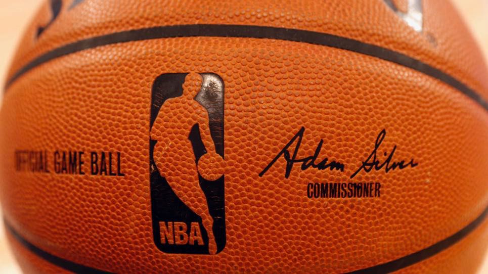 An NBA logo is seen on an official game ball before a basketball game, Feb. 1, 2014, in New York