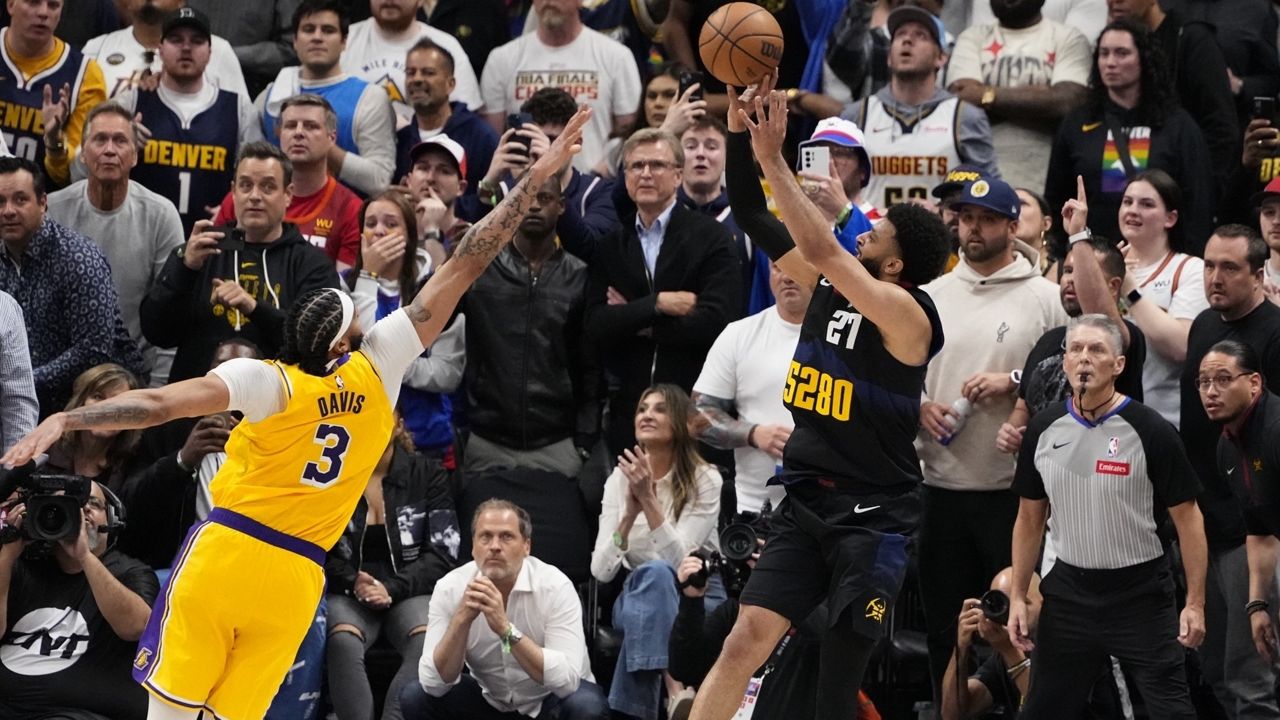 Denver Nuggets guard Jamal Murray (27) hits the game-winning basket against Los Angeles Lakers forward Anthony Davis (3) during the second half in Game 2 of an NBA basketball first-round playoff series Monday, April 22, 2024, in Denver. (AP Photo/Jack Dempsey)