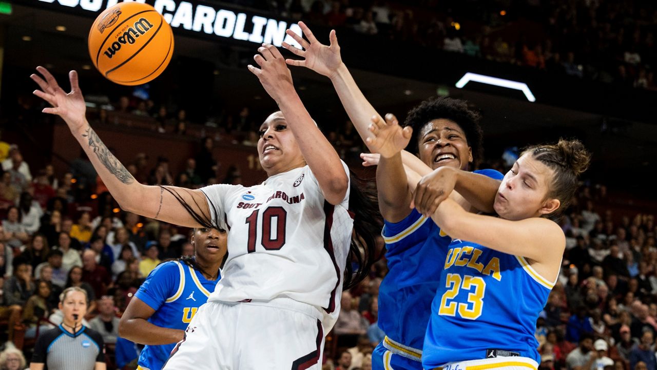 South Carolina's Kamilla Cardoso (10) fights for a rebound over UCLA's Gabriela Jaquez (23) and Christeen Iwuala, center, in the first half of a Sweet 16 college basketball game at the NCAA Tournament in Greenville, S.C., Saturday, March 25, 2023. (AP Photo/Mic Smith)