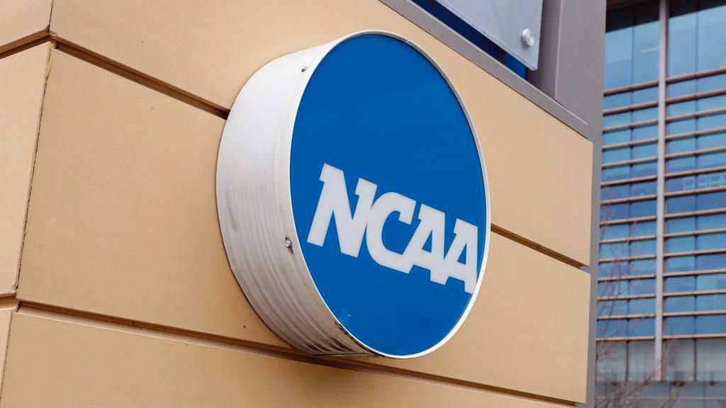 Signage at the headquarters of the NCAA is viewed in Indianapolis, March 12, 2020. (AP Photo/Michael Conroy, File)