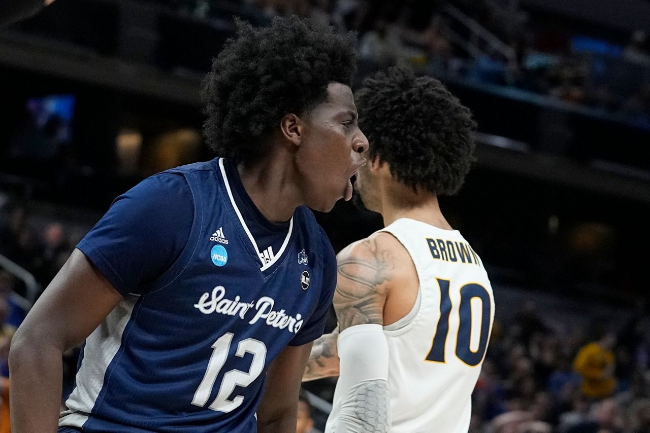 Saint Peter&apos;s Clarence Rupert (12) reacts <b>after</b> hitting a basket and g...