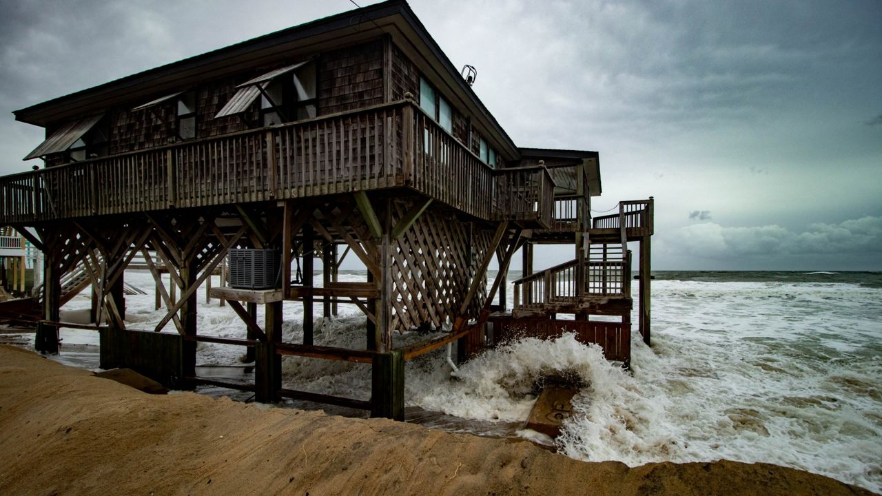 Coastal waves lash a building along the East Coast. (Spectrum News)