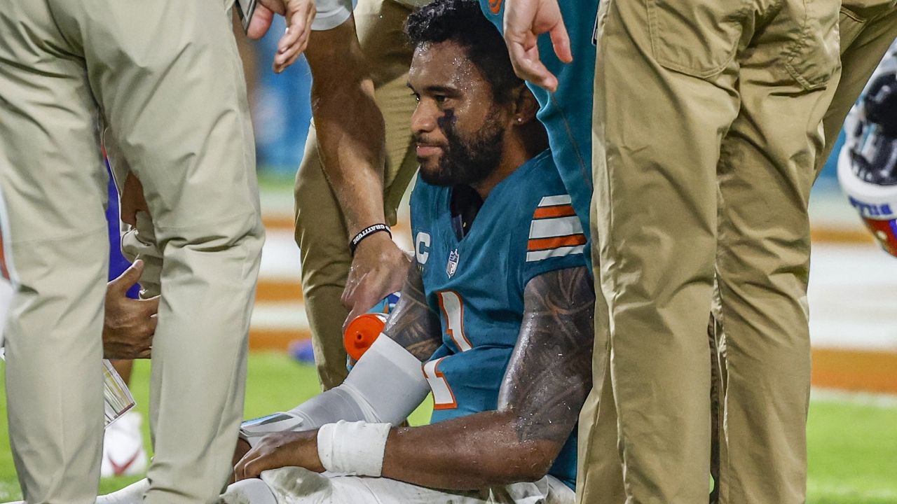 Saint Louis School graduate Tua Tagovailoa sat up after taking a head to the head against the Buffalo Bills at Hard Rock Stadium on Thursday.