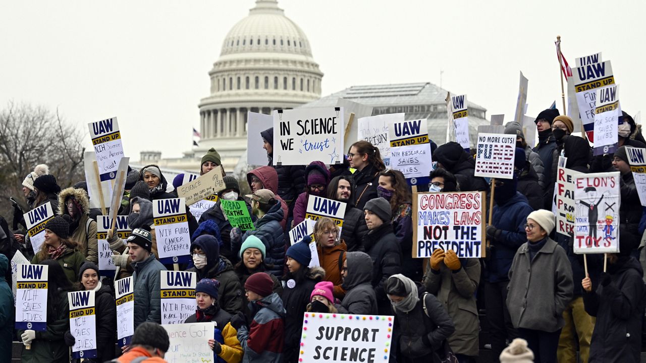 Medical researchers from universities and the National Institutes of Health rally near the Health and Human Services headquarters to protest federal budget cuts Wednesday, Feb. 19, 2025, in Washington. (AP Photo/John McDonnell, File)