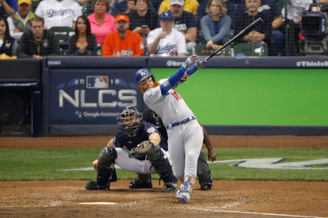 Los Angeles Dodgers' Justin Turner (10) celebrates with Chris Taylor (3)  after hitting a two-run home run during the eighth inning of Game 2 of the  National League Championship Series baseball game