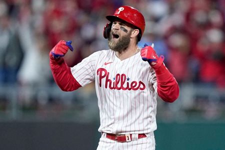 Bryce Harper and Jean Segura of the Philadelphia Phillies react