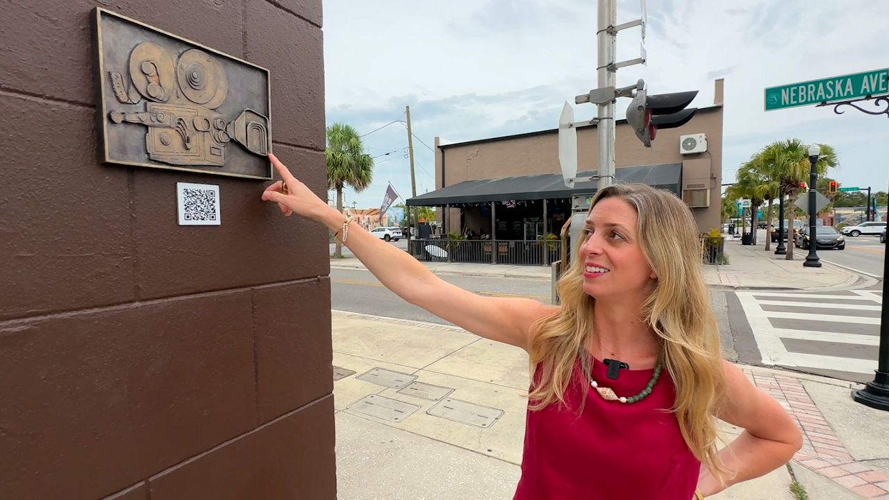 Gillian Harper points out a few hidden details in one of her many new sculptures on display as part of New Port Richey’s 