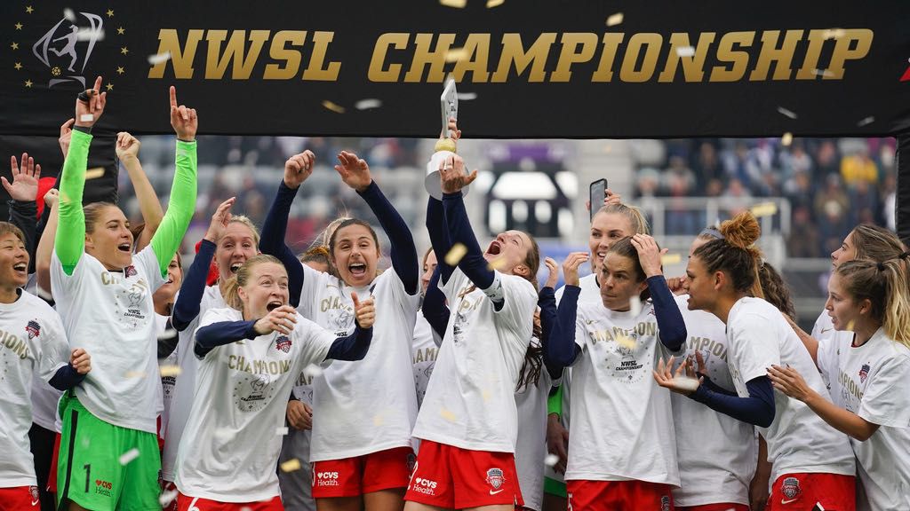 Washington Spirit's Andi Sullivan, center, lifts the trophy as they celebrate after defeating the Chicago Red Stars in the NWSL Championship soccer match, Saturday, Nov. 20, 2021, in Louisville, Ky. (AP Photo/Jeff Dean, File)