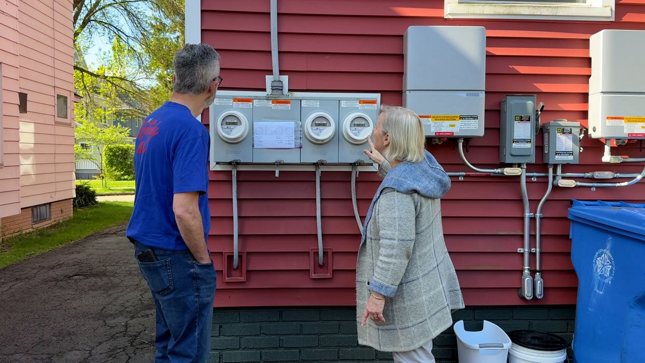 The Millers looking at their solar energy system