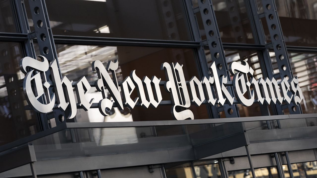 A sign for The New York Times hangs above the entrance to its building in New York. (AP Photo/Mark Lennihan, File)