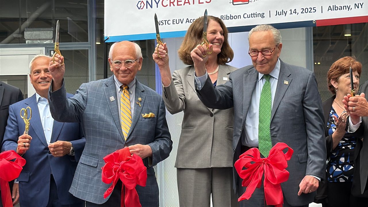 U.S. Rep. Paul Tonko, D-NY; Natcast CEO Deidre Hanford and U.S. Senate Minority Leader Chuck Schumer hold up scissors at Albany NanoTech on Monday after cutting the ribbon on the nation's first-ever National Semiconductor Technology Center at the site. Kate Lisa/Spectrum News 1 photo
