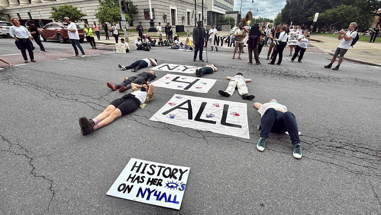 Five Democratic Socialist assemblywomen and dozens of protesters with the New York Immigration Coalition blocked traffic on Washington Avenue in front of the Capitol on Tuesday