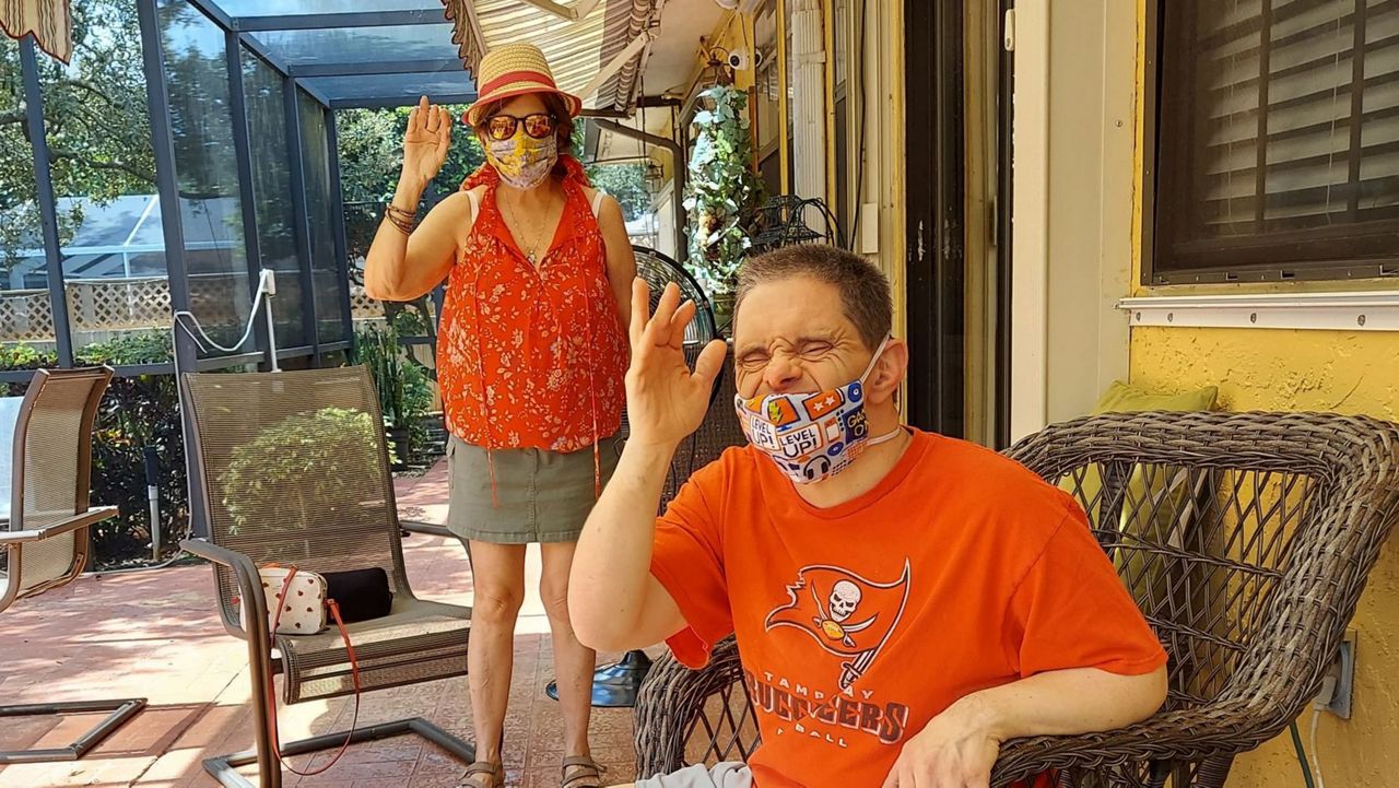 Nancy Torres and her brother, David Alviani, visit for the first time in months (Spectrum News)