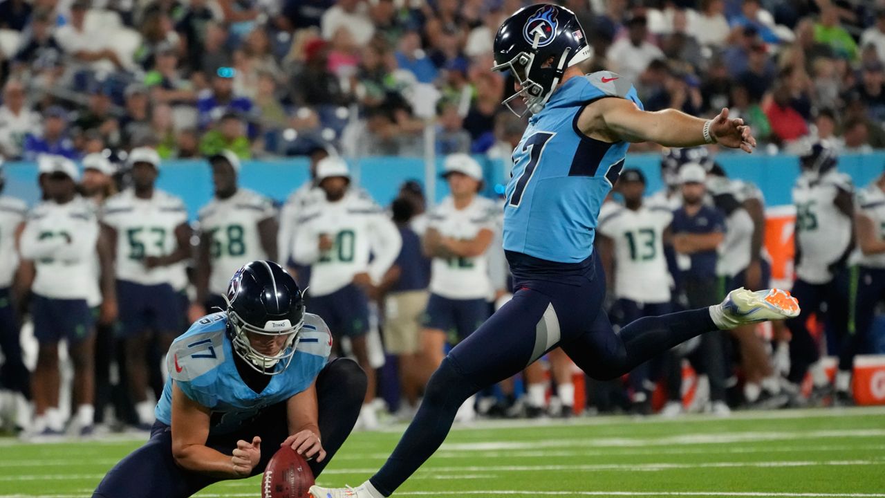 Tennessee Titans place-kicker Brayden Narveson, right, kicks a field goal during the second half of an NFL preseason football game against the Seattle Seahawks, Saturday, Aug. 17, 2024, in Nashville, Tenn. (AP Photo/George Walker IV)