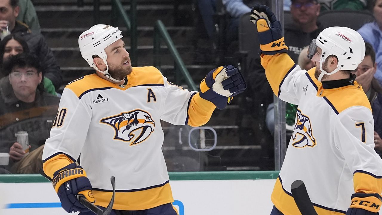 Nashville Predators center Ryan O'Reilly (90) celebrates his goal with teammate Marc Del Gaizo (7) in the second period of an NHL hockey game against the Dallas Stars Thursday, Dec. 12, 2024, in Dallas. (AP Photo/LM Otero)