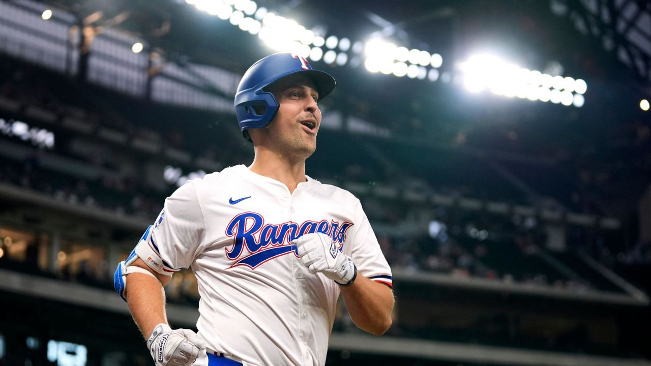 Texas Rangers' Nathaniel Lowe jogs to the dugout after hitting a solo home run in the first inning of a baseball game against the Seattle Mariners in Arlington, Texas, Thursday, April 25, 2024. (AP Photo/Tony Gutierrez)