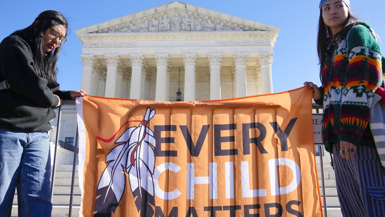 Demonstrators stand outside of the U.S. Supreme Court, as the court hears arguments over the Indian Child Welfare Act on Nov. 9, 2022, in Washington. (AP Photo/Mariam Zuhaib)